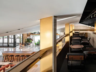 Modern cafe design featuring metallic finishes and wooden furniture.