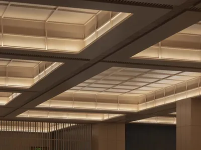 Modern restaurant interior with wooden tables and chairs, elegant lighting, and minimalist design