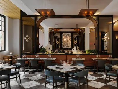 A modern restaurant interior with marble and concrete materials.