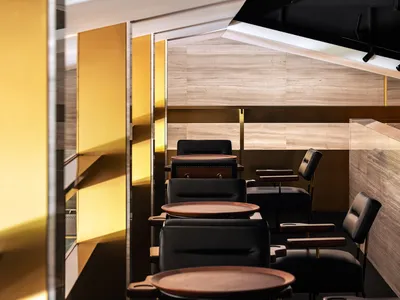 A modern restaurant with marble, metal, and wooden elements.