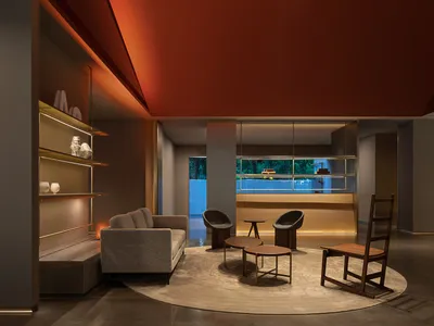 A modern hotel reception area with minimalist furniture, wooden accents, and a sleek design.