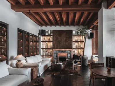 Industrial living room with wooden furniture and exposed beams.