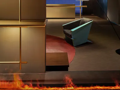 A modern hotel reception with metallic shelving and a sleek, minimalist design.