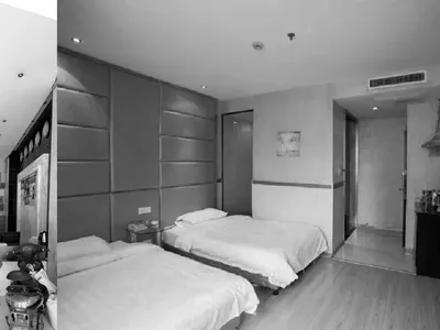 A modern hotel room with glass walls and an air conditioning unit.
