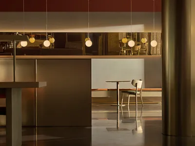 Modern interior design featuring metallic furniture in a restaurant setting.