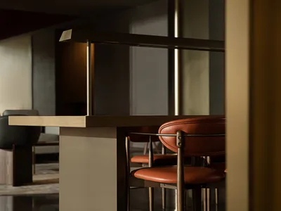 Modern restaurant seating area with wooden furniture and leather upholstery.