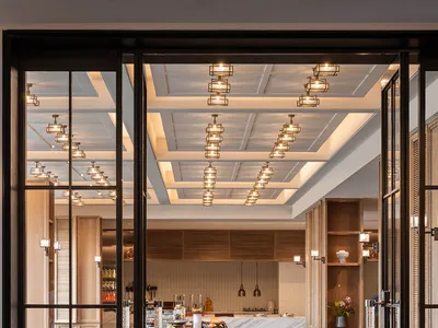 Industrial-style restaurant interior with marble countertops and wooden tables and chairs