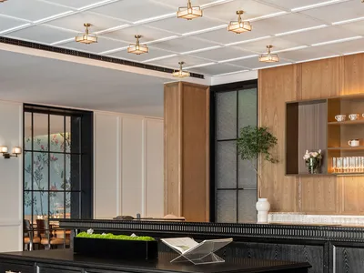 A modern restaurant bar with wooden elements and glass fixtures.