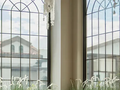 Modern, industrial restaurant interior with large glass windows, minimalist decor, and natural light.