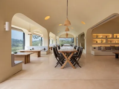 Contemporary cafe interior with wooden furniture and comfortable seating areas.