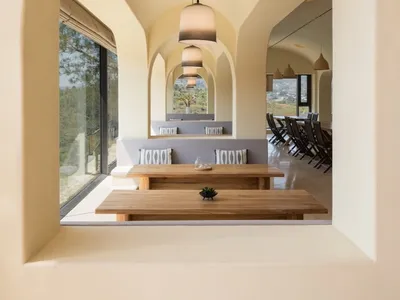 Modern minimalist restaurant interior with wooden tables and benches