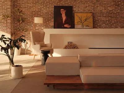 Industrial living room featuring a brick wall and concrete floor.