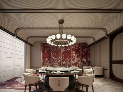 A luxurious restaurant interior featuring a round dining table with marble top, surrounded by upholstered chairs and a decora
