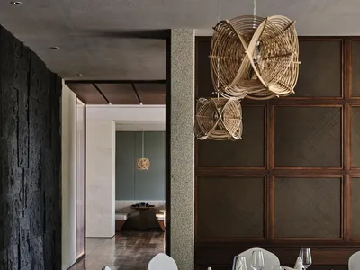 Contemporary-style restaurant interior with wood paneling and a mix of minimalist and natural elements.