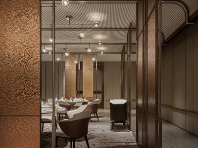 An image of a modern restaurant interior with metallic textures and minimalist design.