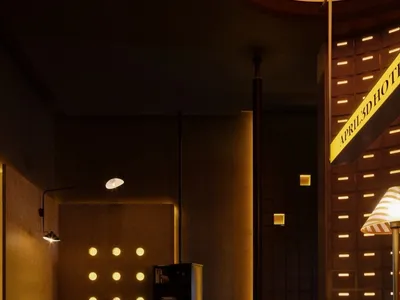 Modern industrial-style hotel reception area with concrete walls and floor tiles.