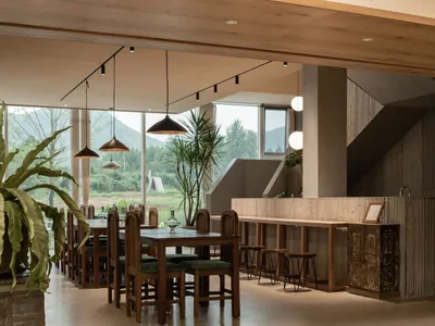A modern restaurant interior featuring natural lighting and wooden elements.