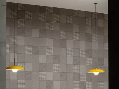 Modern restaurant interior featuring tiled walls with geometric patterns, blue booth seating, and white chairs.