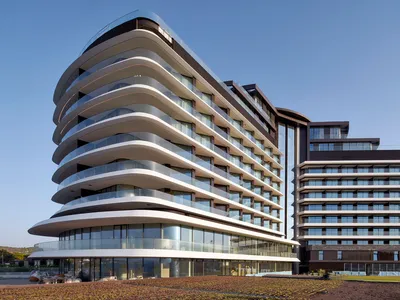 Modern hotel resort building with glass and concrete exterior.