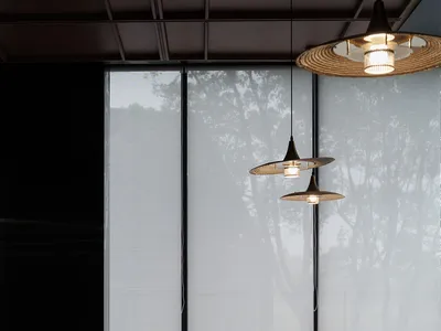 A modern restaurant interior featuring glass walls and minimalistic design elements.
