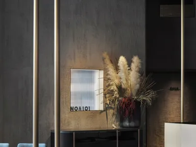 Concrete walls, industrial lighting, and minimalist decor of a restaurant interior