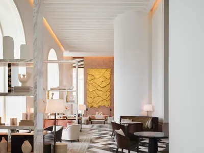 Modern hotel lobby featuring marble flooring and walls.