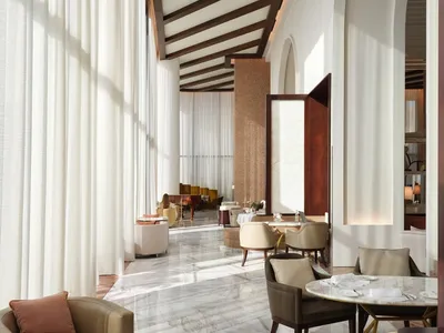 Image of a modern hotel lounge featuring glass, marble, and wood materials.