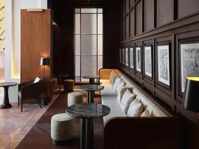 Modern restaurant interior featuring wooden walls and dark wood furniture