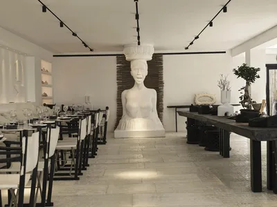 Modern restaurant interior featuring concrete flooring and mixed materials decor.