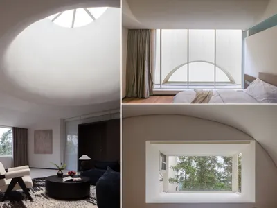 A modern bedroom featuring a large glass window, minimalist furniture, and a cozy ambiance.