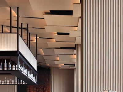 A modern restaurant bar featuring wooden design elements.