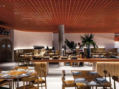Industrial-themed restaurant interior featuring wooden furniture and materials.