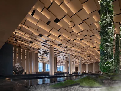 A modern hotel lobby featuring a wooden interior design.