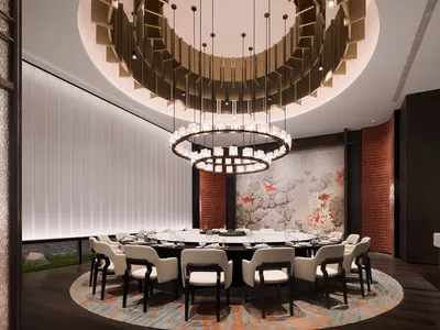 Modern restaurant interior featuring circular glass chandeliers, white chairs with black legs, and a large circular table.