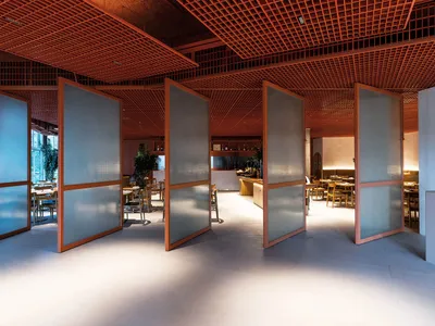 Glass-paneled partitions in a modern restaurant interior