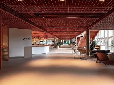 A spacious modern restaurant interior featuring a terrazzo floor and contemporary design elements.
