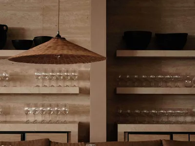 A cozy restaurant interior featuring wooden decor and industrial design elements.