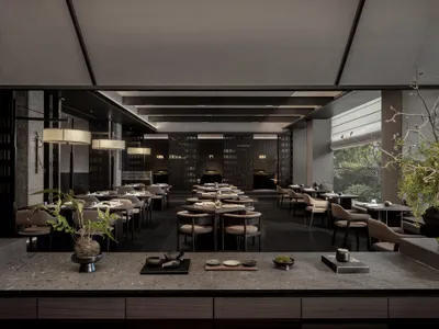 Modern restaurant interior with dark wood furniture, marble countertops, and minimalist design.