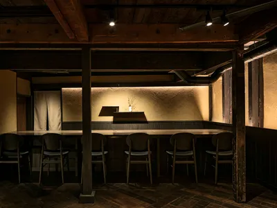 An industrial-style restaurant bar featuring wooden elements and a minimalist design.