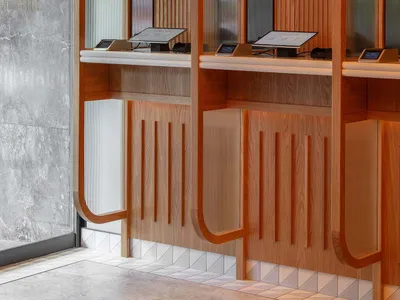 Modern restaurant interior featuring transparent glass walls and wooden fixtures.