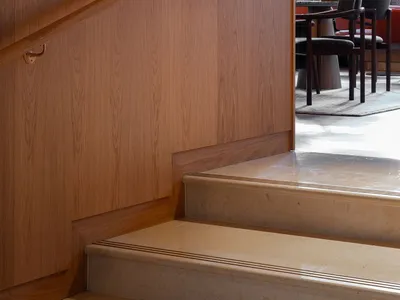 Staircase with wood railings and textured wall