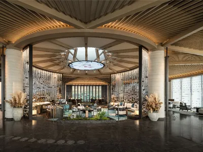 A modern hotel lobby featuring glass and concrete materials