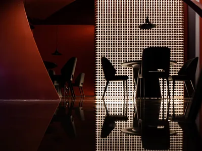 Metallic surfaces and industrial design elements create a contemporary restaurant interior.