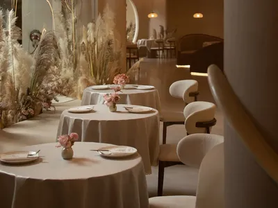 Well-lit restaurant interior featuring modern design with textured wood and concrete elements.