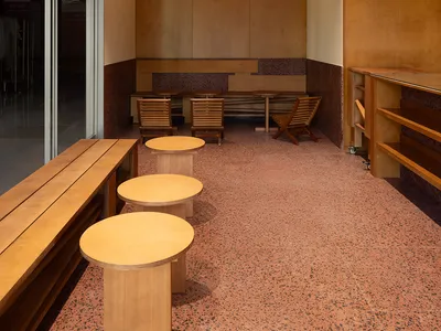 Cafe interior with wooden furniture and terrazzo flooring