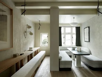Modern restaurant interior with concrete, wood, and leather materials