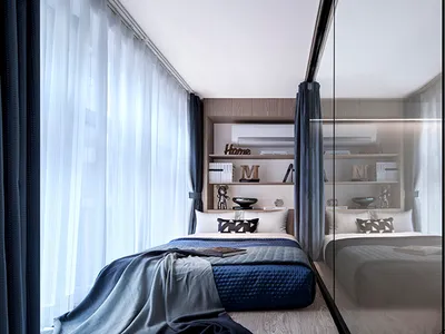 Modern minimalist bedroom with blue fabric bedding, glass doors, and metal accents.
