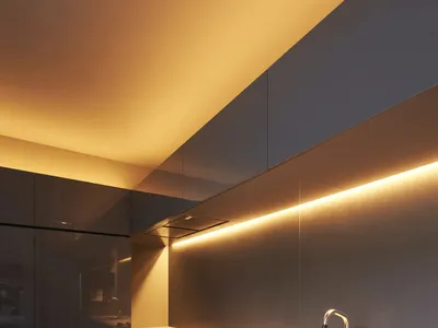 Modern kitchen featuring metallic cabinets and glass backsplash