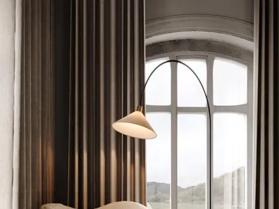 A cozy living room with a white fur chair, a modern glass side table, and a floor lamp with a view of mountains through large
