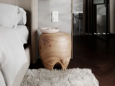A minimalist bedroom showcasing a marble wall and wooden furniture.